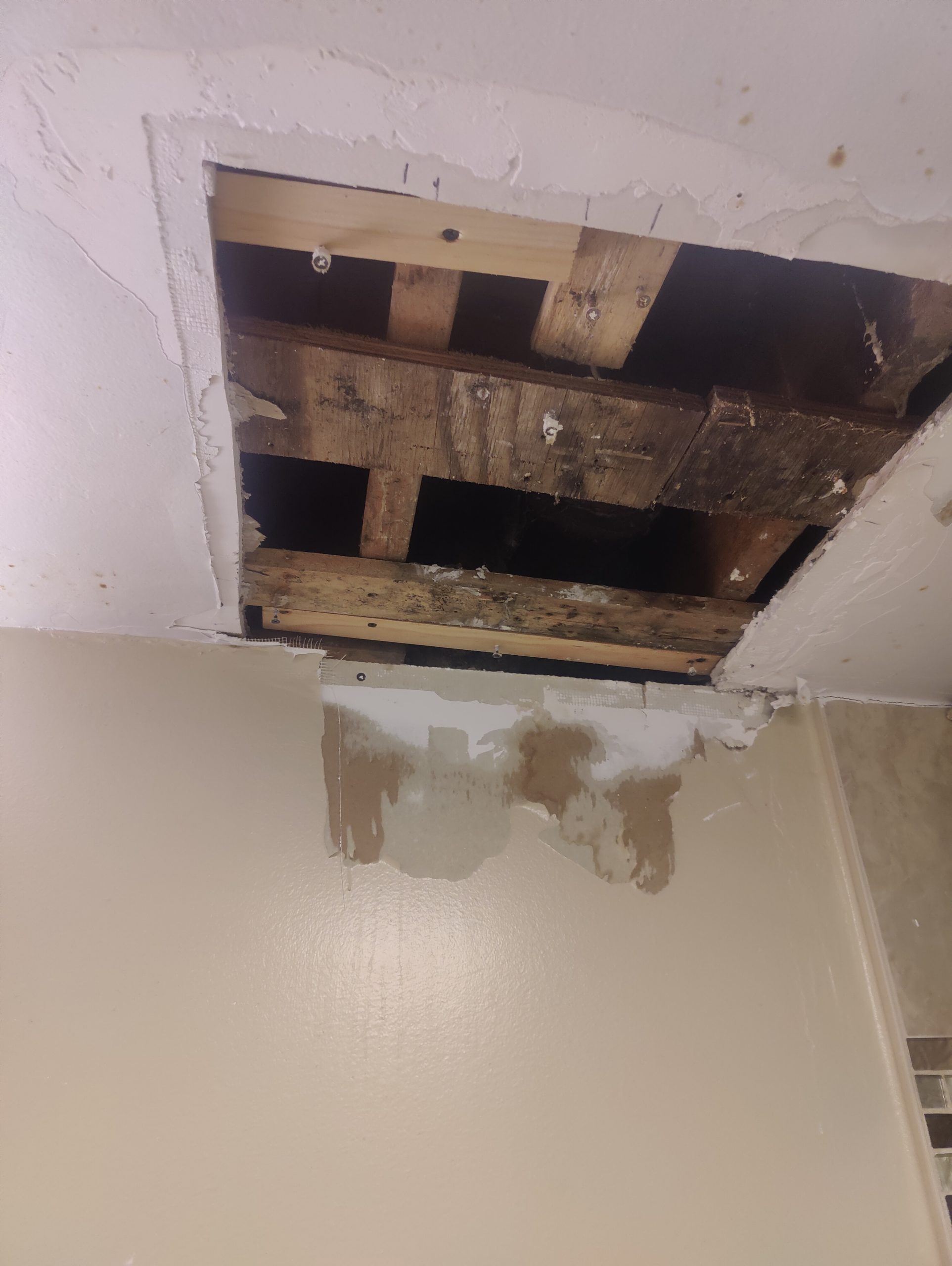 Opened bathroom ceiling before drywall repair in Clinton.