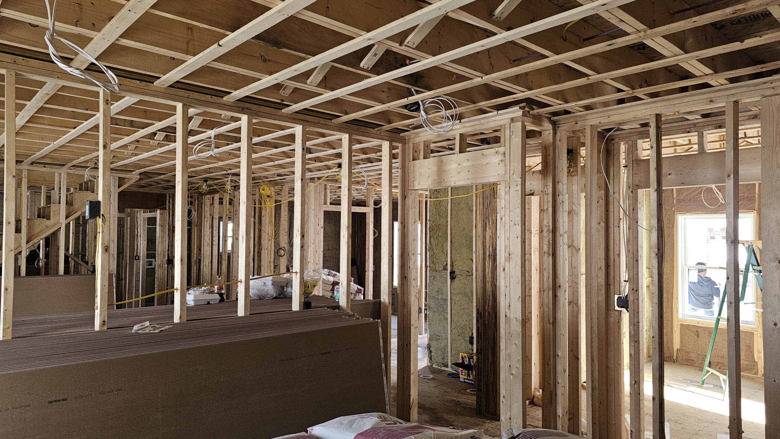 Open wall and ceiling framing before drywall installation in a Worcester project.
