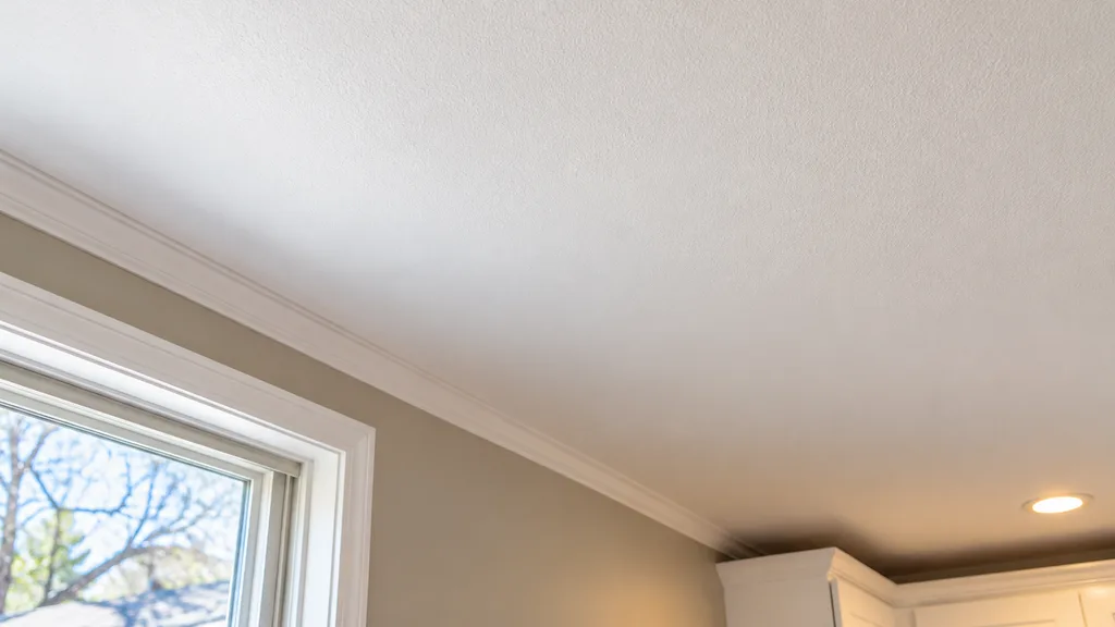 Finished painted drywall ceiling after a localized repair